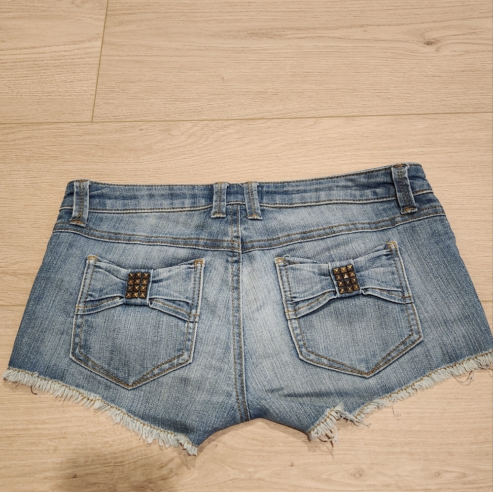 Frankie B. Blue Jean Shorts with Distressed Hem and Bow Back Pockets.